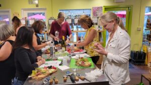 a group of women creating their charcuterie board