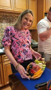 a woman posing for a picture with her charcuterie board