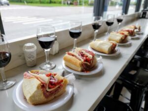 close up of a plate of food and glasses of wine on a table