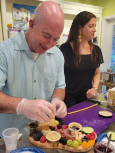 a man and woman preparing food in a kitchen