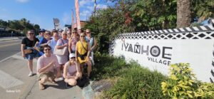 a group of people in front of a sign