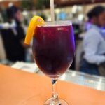 a close up of a wine glass sitting on a table