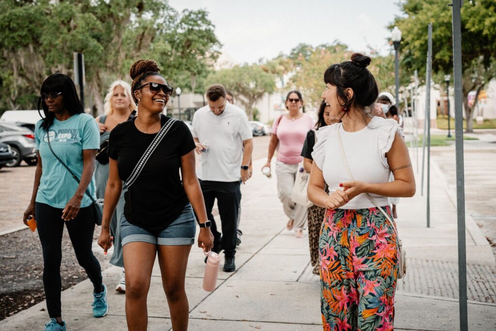 a group of people walking on a sidewalk